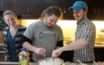 Start From Scratch students learn cooking skills from program creator Dan Clapson (right). Photo courtesy the Calgary Herald archive.