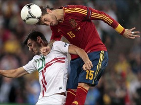 Spain's Sergio Ramos and Portugal's Nelson Oliveira jump for the ball during the Euro 2012 soccer championship semifinal match between Spain and Portugal in Donetsk, Ukraine, Wednesday, June 27, 2012. (AP Photo/Ivan Sekretarev)