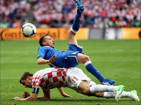 Emanuele Giaccherini of Italy clashes with Darijo Srna of Croatia during the UEFA EURO 2012 group C match between Italy and Croatia at The Municipal Stadium on June 14, 2012 in Poznan, Poland.  (Photo by Clive Mason/Getty Images)