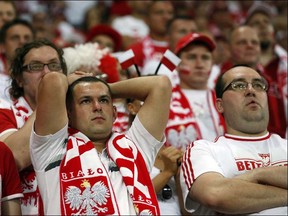 Dejected Polish fans stand after the Euro 2012 soccer championship Group A match between Czech Republic and Poland in Wroclaw, Poland, Saturday, June 16, 2012. (AP Photo/Jon Super)