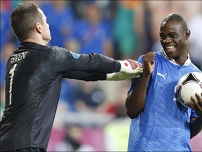 Italy's Mario Balotelli reacts to Ireland goalkeeper Shay Given during the Euro 2012 soccer championship Group C match between Italy and the Republic of Ireland in Poznan, Poland, Monday, June 18, 2012. (AP Photo/Jon Super)
