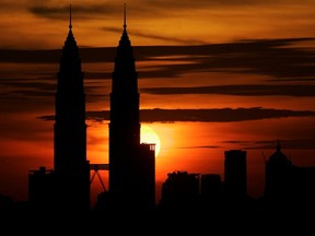 The Petronas Twin Towers rise above Kuala Lumpur. The price the Malaysian national company is paying for Progress Energy rises above similar deals struck this year in Western Canada.