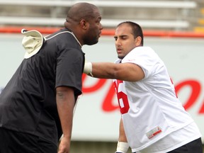 Stamps' top draft pick Ameet Pall, right, works with defensive line coach DeVone Claybrooks during training camp. Photo, Colleen De Neve, Calgary Herald