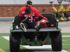 Stamps receiver Maurice Price shows his disappointment as he's carted off the field on Saturday morning. Photo, Christina Ryan, Calgary Herald