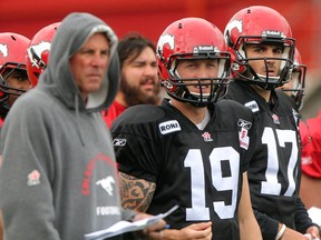 Stamps coach and GM John Hufnagel, left, has to decide between Bo Levi Mitchell (19) and Brad Sinopoli (15) for the No. 3 quarterback job. Photo, Colleen De Neve, Calgary Herald