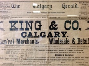 The top of the front page of the Calgary Herald from Wednesday, October 8, 1884. It's on display behind glass (hence the reflections) in the Herald newsroom.