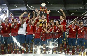 Spanish players celebrate with the trophy after winning the Euro 2012 football championships final match Spain vs Italy on July 1, 2012 at the Olympic Stadium in Kiev.        PIERRE-PHILIPPE MARCOU/AFP/GettyImages