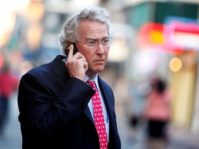 Former Chesapeake Energy CEO Aubrey McClendon talks on a phone.