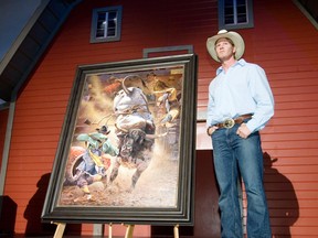 Artist Don Oelze stands beside his painting of the bull Outlaw which was unveiled as the 2010 Stampede poster.