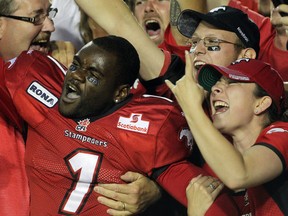 Stamps running back LaMarcus Coker celebrates with fans after Calgary's overtime win over Saskatchewan. Photo, Colleen De Neve, Calgary Herald