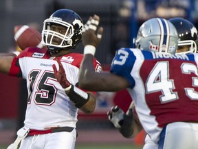 Stamps quarterback Kevin Glenn delivers a pass under pressure from Alouettes linebacker Kenny Ingram on Thursday night in Montreal. Photo, Paul Chiasson, Canadian Press