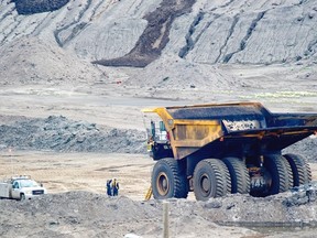 Giant truck moves through Syncrude Canada oilsands mine.