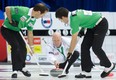 Sweepers Brent Laing, left, and Craig Savill brush a stone thrown by skip Glenn Howard during a 2011 Grand Slam event in Oshawa. Photo, Anil Mungal/Capital One