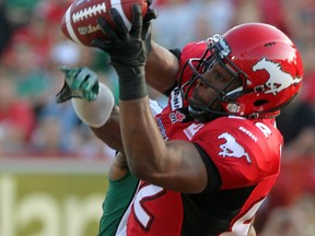 Nik Lewis makes one of his three touchdown catches against the Saskatchewan Roughriders in the Stamps' overtime win last month at McMahon Stadium. Photo, Colleen De Neve, Calgary Herald