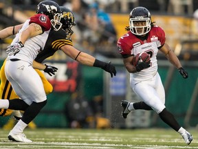 Stamps returner Larry Taylor, named the Special Teams Player of the Week on Tuesday, takes advantage of an Eric Fraser block to put together a big punt return last Thursday in Hamilton. Photo, Geoff Robins, Canadian Press
