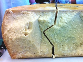 Cutting Parmagiano Reggiano into quarters. Photo by Gwendolyn Richards, Calgary Herald.