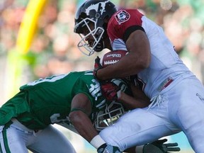 Roughriders defensive back Terrell Maze puts a hit on Stamps running back Jon Cornish during the Riders' 30-25 win at Mosaic Stadium on Sunday. Photo, Liam Richards, The Canadian Press