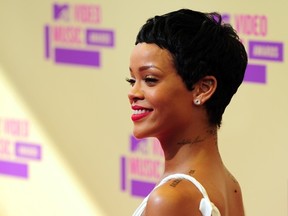 Rihanna poses on arrival on the red carpet for the MTV Video Music Awards in Los Angeles on September 6, 2012 in California.