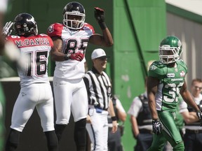 Stamps receiver Joe West, right, celebrates his first-quarter touchdown against the Saskatchewan Roughriders with teammate Marquay McDaniel. Photo, Liam Richards, The Canadian Press.