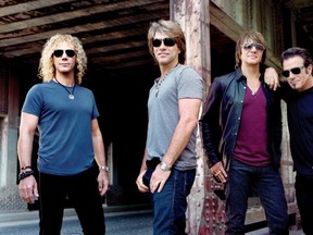 Here is a picture of Bon Jovi, who are headed to Calgary for an April 2, 2013 show, standing near a bridge or a warehouse. For no reason in particular