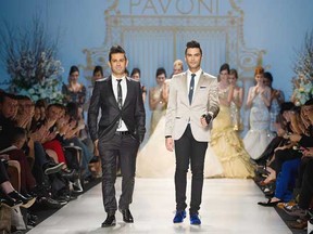 Montreal designers Mike Derderian, left and Gianni Falcone walk the runway to close the Pavoni fashion show during opening night of Toronto Fashion Week. The Canadian Press.