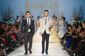 Montreal designers Mike Derderian, left and Gianni Falcone walk the runway to close the Pavoni fashion show during opening night of Toronto Fashion Week. The Canadian Press.