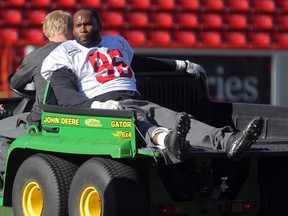 Stamps defensive tackle Demonte' Bolden is carted off to the locker-room during practice on Thursday. He returned to the field later, and should be able to play on Saturday. Photo, Colleen De Neve, Calgary Herald