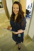 Arlette Watwood showcases her iPad outside her office at Cenovus Energy.