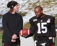 Drew Tate, with his right arm in a cast, chats with Kevin Glenn during Thursday's practice at McMahon Stadium. Photo, Gavin Young, Calgary Herald