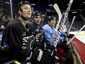 Calgary Flames, left to right, Jay Bouwmeester, Mark Giordano, and Brad Winchester, watch a drill during training camp in Calgary, Alta., Monday, Jan. 14, 2013.THE CANADIAN PRESS/Jeff McIntosh