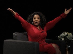 Oprah Winfrey acknowledges the audience after she came to the stage for an interview with Ball State University alumnus David Letterman, host of CBS's "Late Show," at Ball State University in Muncie, Ind., Monday, Nov. 26, 2012. The conversation is part of the David Letterman Distinguished Professional Lecture and Workshop Series. (AP Photo/Michael Conroy)