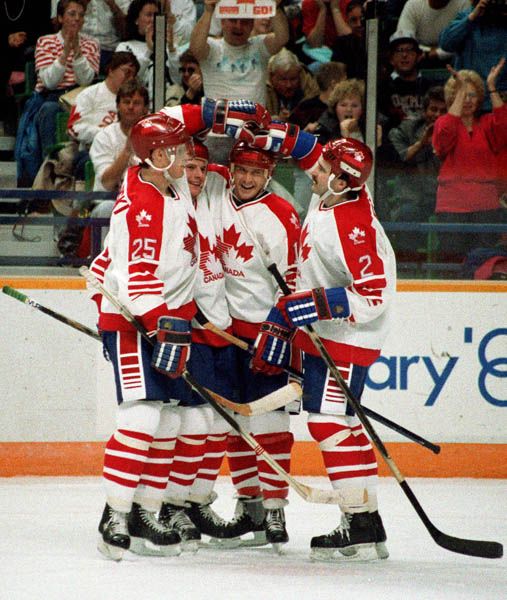 Canada's men's hockey team celebrate during  hockey action at the 1988 Winter Olympics in Calgary. (CP PHOTO/ COA/ S.Grant)