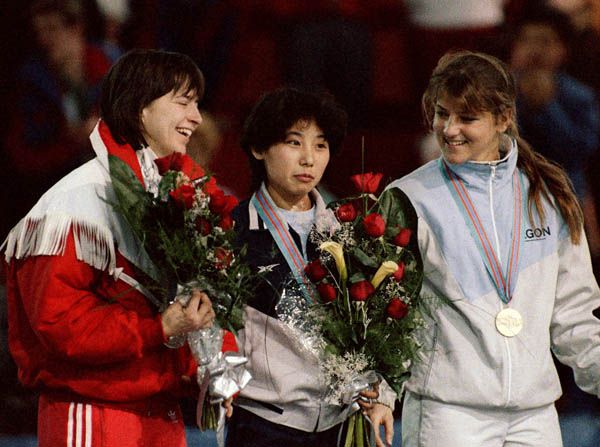 Sylvie Daigle, left, celebrates her silver medal in the 1000m short track speed skating event.