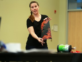 Christie Springs show off custom decals as she pitches Rovers Briefcase to show producers at the CBC Dragons' Den auditions at Mount Royal College on Saturday.  The product is a stylish and smell free way to carry your dog's droppings after a romp in the dog park.
Gavin Young/Calgary Herald