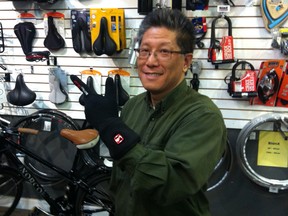 Ken Cheung of Calgary's Power in Motion shows off his heated gloves in this Eau Claire store