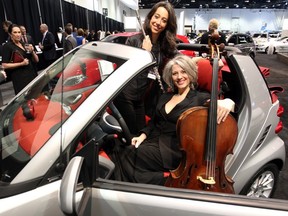 Flautist Mary Sullivan, left, and cellist Morag Northey were some of the Calgary Philharmonic Orchestra musicians at the annual Vehicles and Violins event Tuesday which kicked off the Calgary Auto Show.