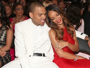 Rihanna snuggles up to boyfriend Chris Brown at the Grammy Awards on Feb. 10, 2013.