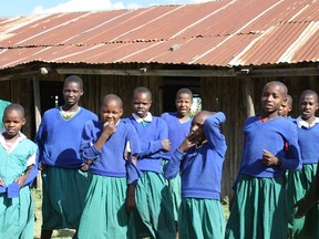 Students at Enelerai Primary School stand in front of the old school building they had before Free the Children constructed a new school for them in Kenya. Photos by Monica Zurowski.