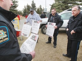 Union members picket outside the Calgary Correctional Centre as they take part in a wildcat strike.