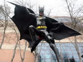 The Comic & Entertainment Expo swoops down on Calgary, as Patrick Shenier, Batman, gets ready for the Parade of Wonders starting at Eau Claire. Christina Ryan, Calgary Herald