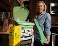 Anne Logan with her under-the-sink compost container. Photo: Stuart Gradon, Calgary Herald