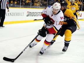 Calgary Flames center Roman Cervenka (10), of the Czech Republic, keeps the puck from Nashville Predators defenseman Kevin Klein (8) in the first period of an NHL hockey game, Tuesday, April 23, 2013, in Nashville, Tenn. (AP Photo/Mike Strasinger)