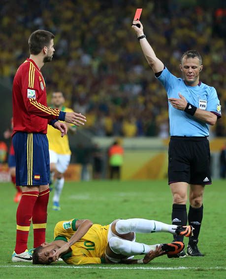 Gerard Pique of Spain is shown a red card by Referee Bjorn Kuipers for a tackle on Neymar of Brazil during the FIFA Confederations Cup Brazil 2013 Final match between Brazil and Spain at Maracana on June 30, 2013 in Rio de Janeiro, Brazil.  (Photo by Jasper Juinen/Getty Images)