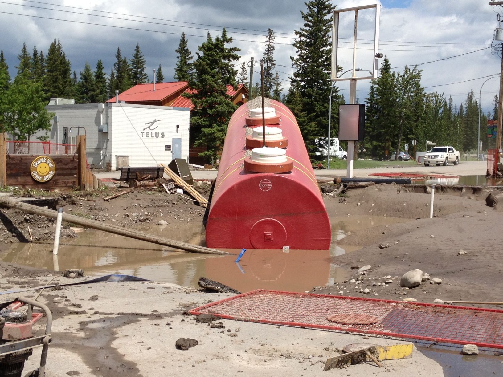 A massive tank sits askew on the site of a demolished gas station in Bragg Creek. (Michele Jarvie/Calgary Herald)