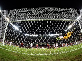 Iker Casillas of Spain is unable to stop Luis Suarez of Uruguay scoring his team's first goal from a free-kick during the FIFA Confederations Cup Brazil 2013 Group B match between Spain and Uruguay at the Arena Pernambuco on June 16, 2013 in Recife, Brazil.  (Photo by Clive Rose/Getty Images)