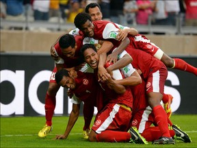 Jonathan Tehau of Tahiti celebrates with his team-mates after scoring his team's first goal during the FIFA Confederations Cup Brazil 2013 Group B match between Tahiti and Nigeria at Governador Magalhaes Pinto Estadio Mineirao on June 17, 2013 in Belo Horizonte, Brazil. (Photo by Laurence Griffiths/Getty Images)
