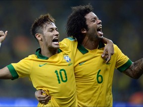 Brazil's forward Neymar (L) and defender Marcelo celebrate after midfielder Paulinho scored against Uruguay during their FIFA Confederations Cup Brazil 2013 semifinal football match, at the Mineirao Stadium in Belo Horizonte on June 26, 2013.  Photo: VANDERLEI ALMEIDA/AFP/Getty Images