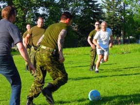 On Sunday night, Inglewood residents held a community barbecue to deal with their defrosting freezer contents. Organizer Ed Top invited members of the military, in Inglewood to held fend off floodwaters, to join in for a bite and show off their soccer skills. (Michelle Gritter photo)