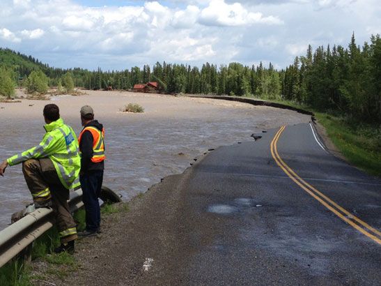 West of Trading Post near Bragg Creek, which you can see barely hanging on in background. Road washed away. (Michele Jarvie/Calgary Herald)