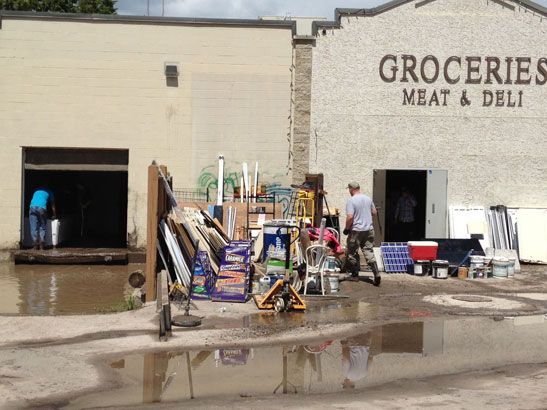 Cleanup efforts at the Bragg Creek grocer. (Michele Jarvie/Calgary Herald)